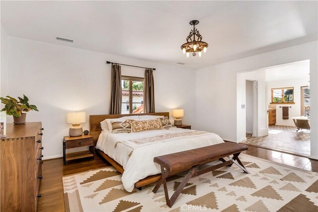 2020 N Victoria Dr, Santa Ana, CA 92706 - bedroom featuring wood finished floors, multiple windows, and baseboards