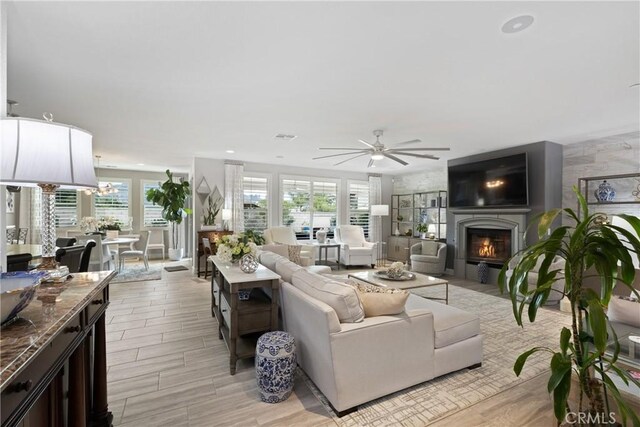 28934 Rangeview Dr, Murrieta, CA 92563 - living area featuring a ceiling fan, a glass covered fireplace, a chandelier, light wood-type flooring, and recessed lighting