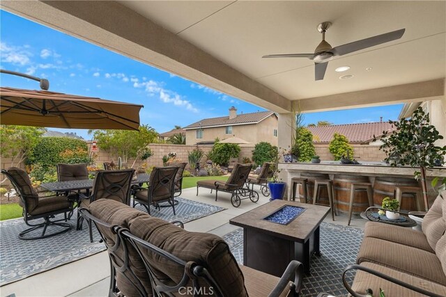 28934 Rangeview Dr, Murrieta, CA 92563 - view of patio with a fire pit, a fenced backyard, outdoor dining area, and ceiling fan