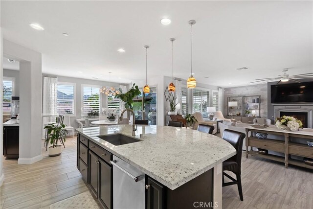 28934 Rangeview Dr, Murrieta, CA 92563 - kitchen with a sink, dishwasher, open floor plan, light wood-style floors, and a ceiling fan