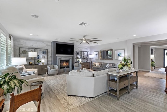28934 Rangeview Dr, Murrieta, CA 92563 - living area with a ceiling fan, healthy amount of natural light, a glass covered fireplace, light wood-type flooring, and recessed lighting