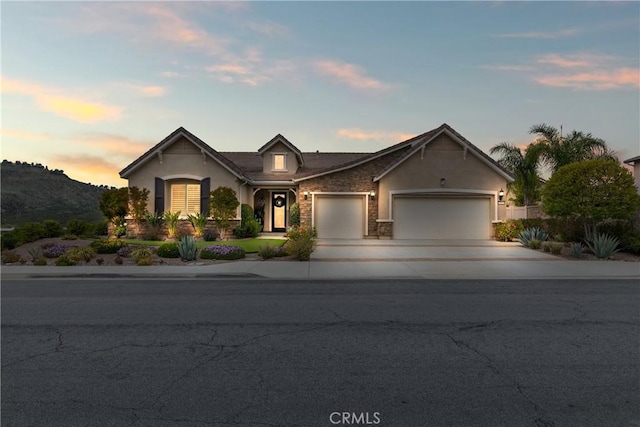 28934 Rangeview Dr, Murrieta, CA 92563 - view of front of property featuring an attached garage, concrete driveway, stucco siding, and stone siding