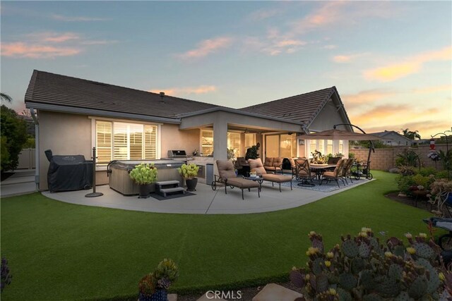 28934 Rangeview Dr, Murrieta, CA 92563 - back of house featuring a hot tub, a patio, stucco siding, and a tiled roof
