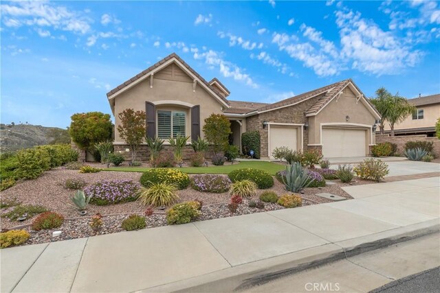28934 Rangeview Dr, Murrieta, CA 92563 - single story home featuring a garage, driveway, stucco siding, and stone siding