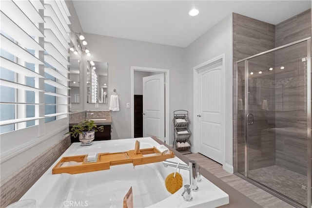 28934 Rangeview Dr, Murrieta, CA 92563 - bathroom featuring a shower stall, vanity, wood finished floors, and a tub to relax in