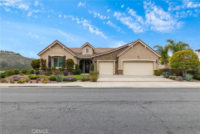 28934 Rangeview Dr, Murrieta, CA 92563 - view of front of home with an attached garage, stucco siding, concrete driveway, and stone siding