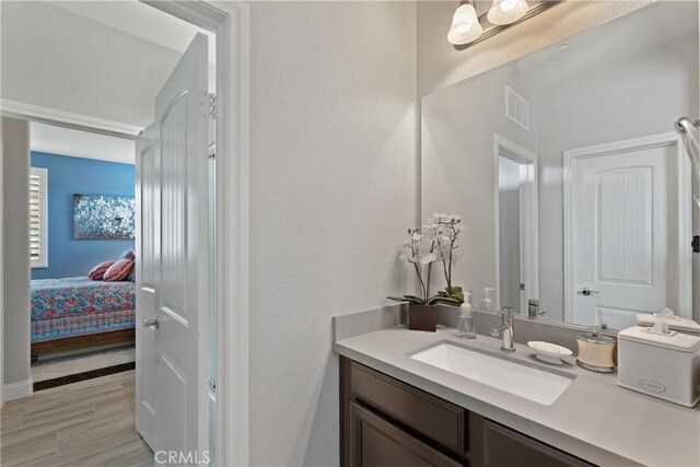 28934 Rangeview Dr, Murrieta, CA 92563 - ensuite bathroom featuring vanity and wood finished floors