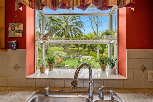 3161921 Via Puerta Del Sol, Bonsall, CA 92003 - room details featuring light stone counters, tasteful backsplash, and a sink