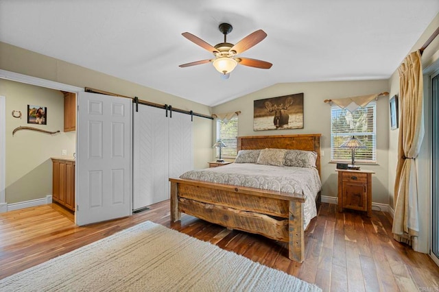 3161921 Via Puerta Del Sol, Bonsall, CA 92003 - bedroom with a barn door, wood-type flooring, baseboards, a ceiling fan, and lofted ceiling