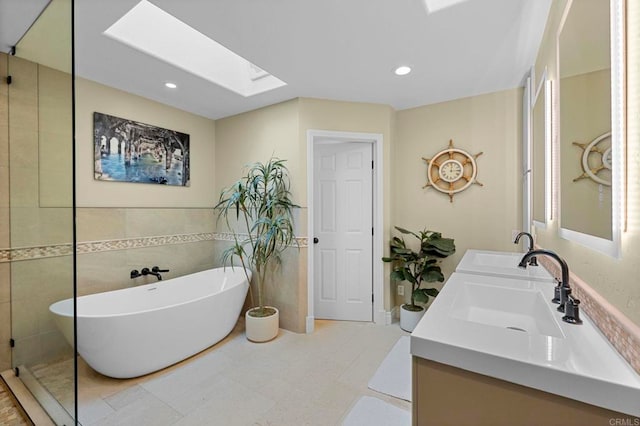 3161921 Via Puerta Del Sol, Bonsall, CA 92003 - bathroom with a sink, tile walls, a freestanding bath, and a skylight