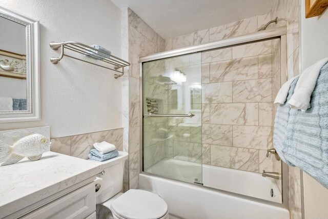 1202 N Pacific St Unit 201B, Oceanside, CA 92054 - bathroom featuring vanity, toilet, and shower / bath combination with glass door