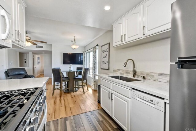 1202 N Pacific St Unit 201B, Oceanside, CA 92054 - kitchen with ceiling fan, visible vents, appliances with stainless steel finishes, a sink, and light wood-style floors