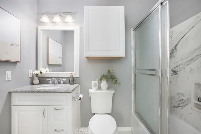 bathroom featuring bath / shower combo with glass door, toilet, and vanity