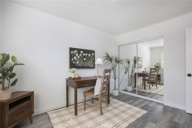 office space with baseboards and wood finished floors