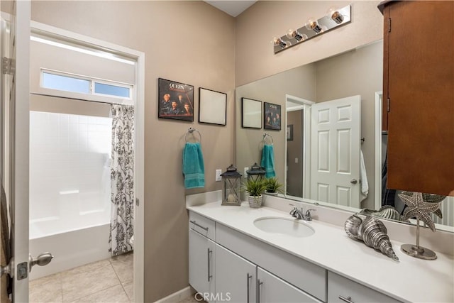 bathroom with shower / bath combo with shower curtain, vanity, and tile patterned flooring