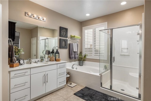 full bathroom featuring recessed lighting, a shower stall, vanity, a bath, and tile patterned floors