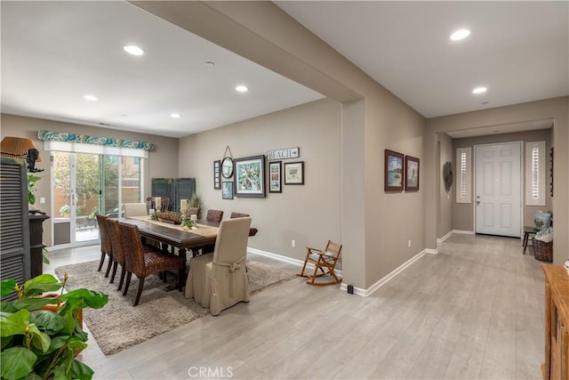 dining space with recessed lighting, light wood finished floors, and baseboards