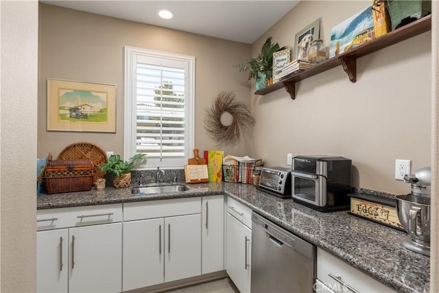kitchen featuring a sink, open shelves, a toaster, white cabinetry, and stainless steel dishwasher