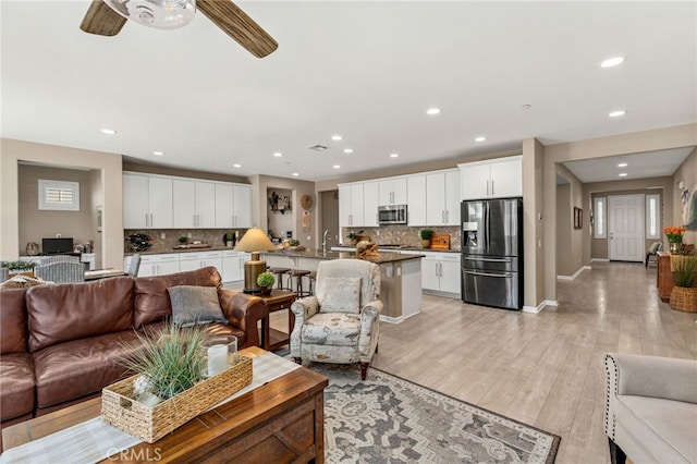 30525 Hawkscrest Rd, Murrieta, CA 92563 - living area with recessed lighting, baseboards, light wood-type flooring, ceiling fan, and healthy amount of natural light