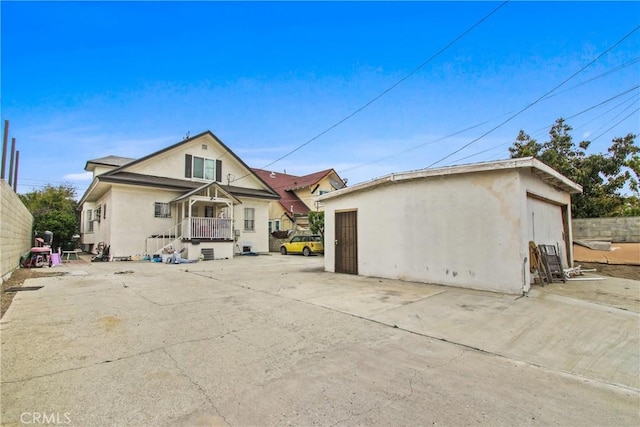 back of house featuring stucco siding and a garage