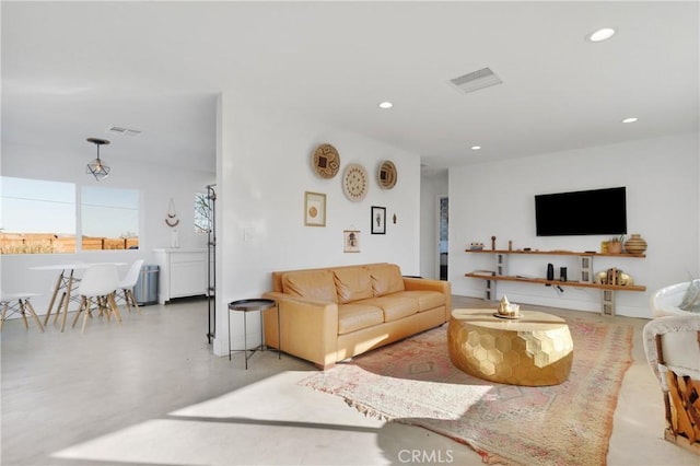 living room featuring visible vents, recessed lighting, and finished concrete flooring