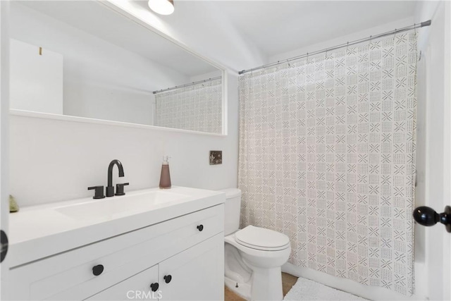 bathroom with toilet and vanity