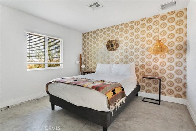 bedroom featuring visible vents and baseboards