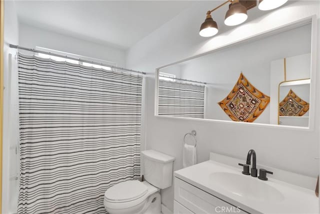 bathroom with toilet, curtained shower, and vanity