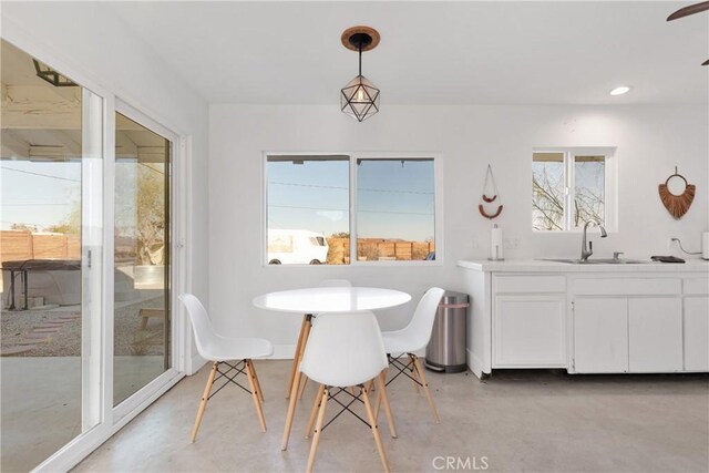 dining space featuring recessed lighting and concrete floors