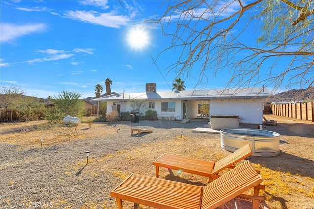 view of front of home featuring a hot tub and fence