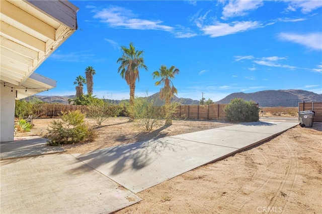 4789 Avenida Del Sol, Joshua Tree, CA 92252 - fenced backyard with a mountain view and a patio area
