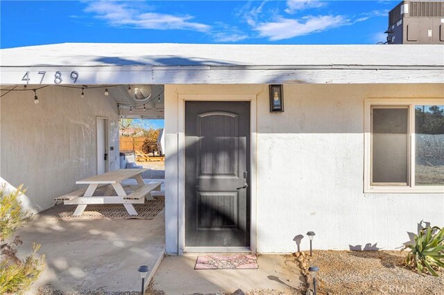 4789 Avenida Del Sol, Joshua Tree, CA 92252 - doorway to property with a patio area and stucco siding