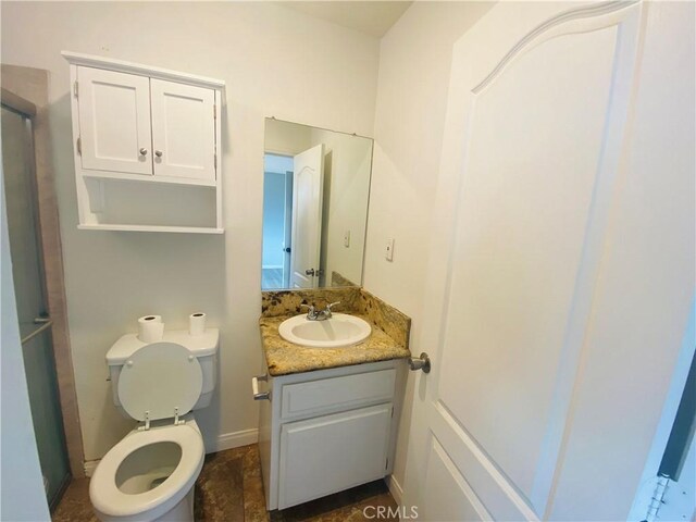 bathroom with toilet and vanity