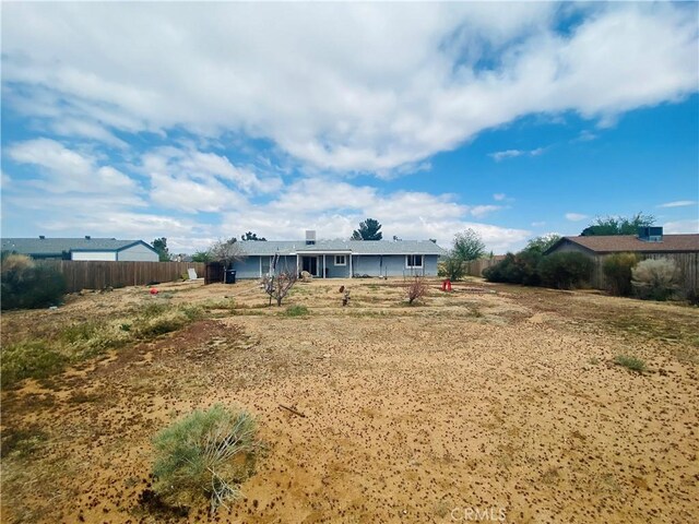rear view of house with fence