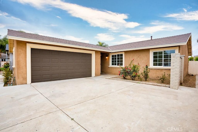 single story home featuring stucco siding, concrete driveway, and an attached garage