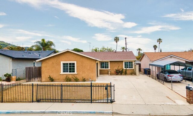 view of front facade featuring fence private yard, stucco siding, and concrete driveway
