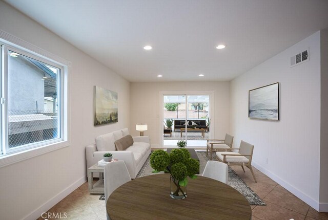 living room featuring light tile patterned floors, visible vents, recessed lighting, and baseboards