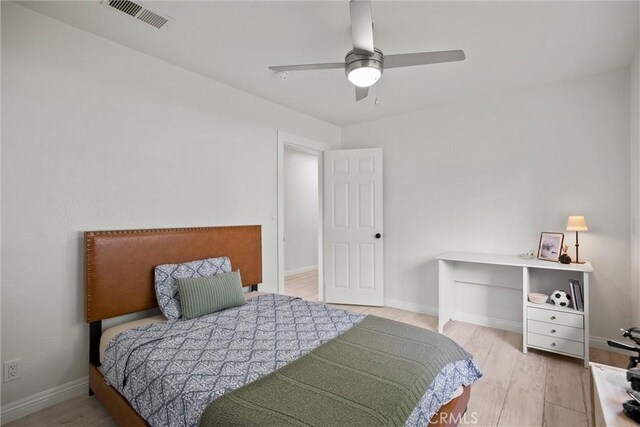 bedroom with visible vents, ceiling fan, wood finished floors, and baseboards