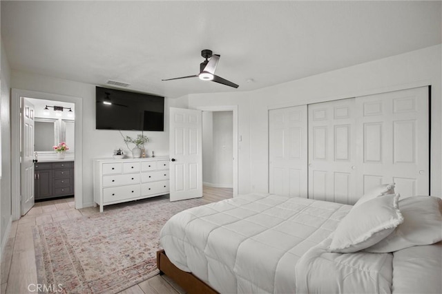 bedroom featuring a closet, light wood-type flooring, a ceiling fan, visible vents, and baseboards