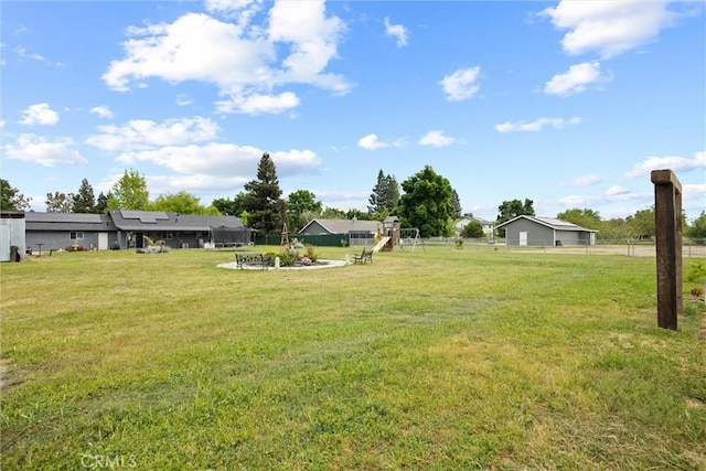 view of yard with playground community and fence