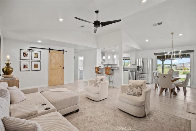 living room featuring visible vents, a barn door, ceiling fan with notable chandelier, and recessed lighting