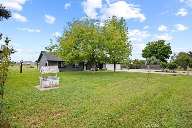 view of yard with concrete driveway