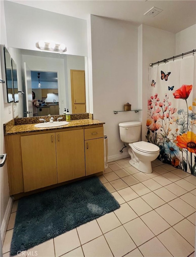 630 W 6th St Unit 611, Los Angeles, CA 90017 - bathroom featuring tile patterned floors, toilet, vanity, baseboards, and a shower with shower curtain