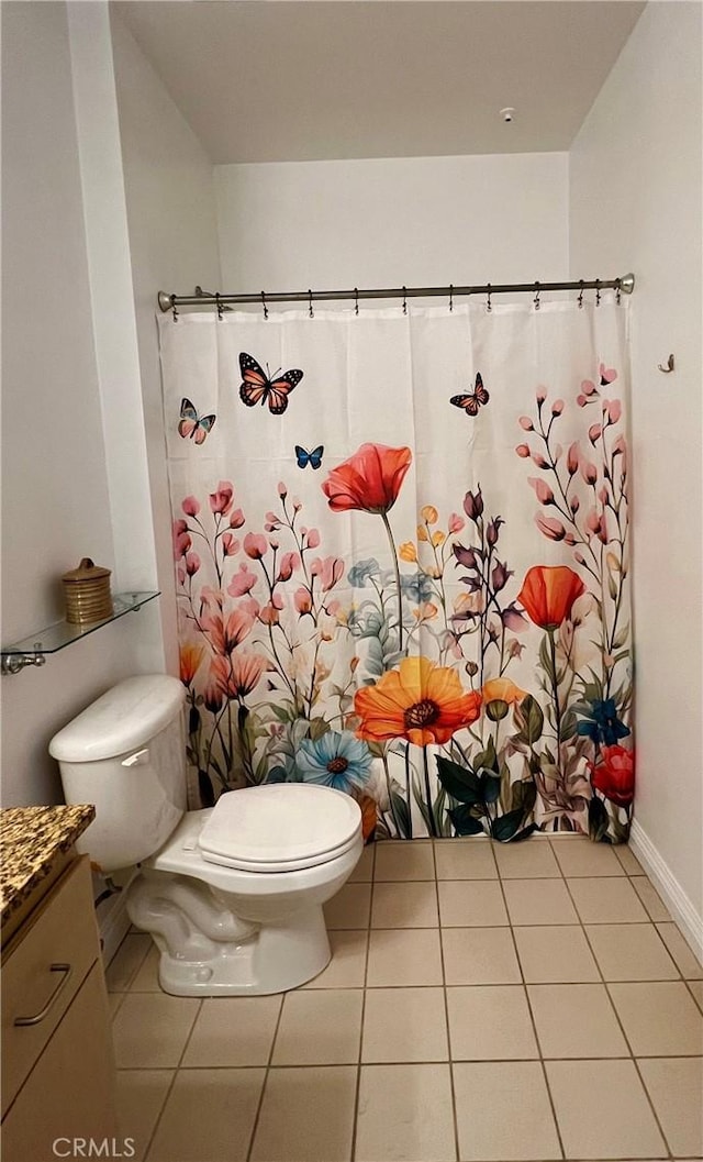 630 W 6th St Unit 611, Los Angeles, CA 90017 - bathroom featuring toilet, tile patterned floors, vanity, baseboards, and a shower with curtain