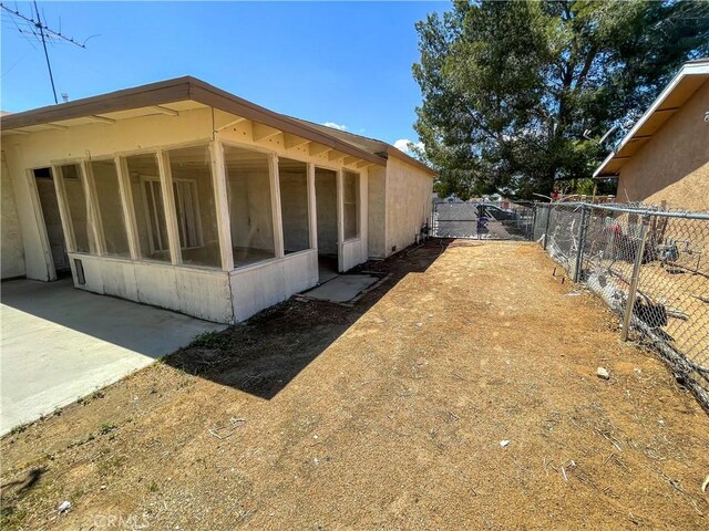 18225 Casaba Rd, Adelanto, CA 92301 - view of side of property featuring a sunroom and fence