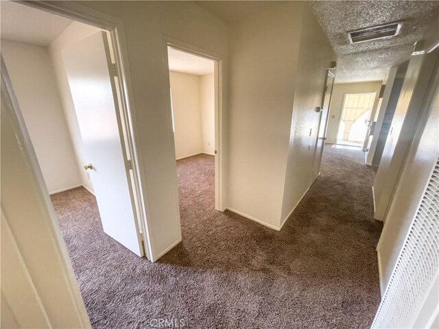 18225 Casaba Rd, Adelanto, CA 92301 - corridor featuring visible vents, a textured ceiling, and carpet