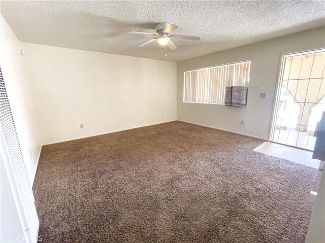 18225 Casaba Rd, Adelanto, CA 92301 - spare room with carpet, a ceiling fan, a textured ceiling, and a wealth of natural light