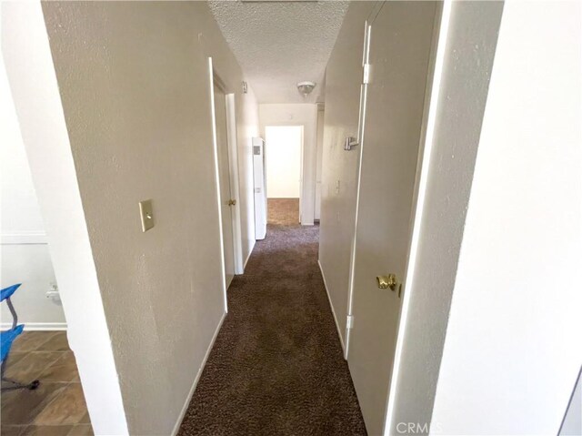 18225 Casaba Rd, Adelanto, CA 92301 - hall with carpet floors, a textured ceiling, and baseboards