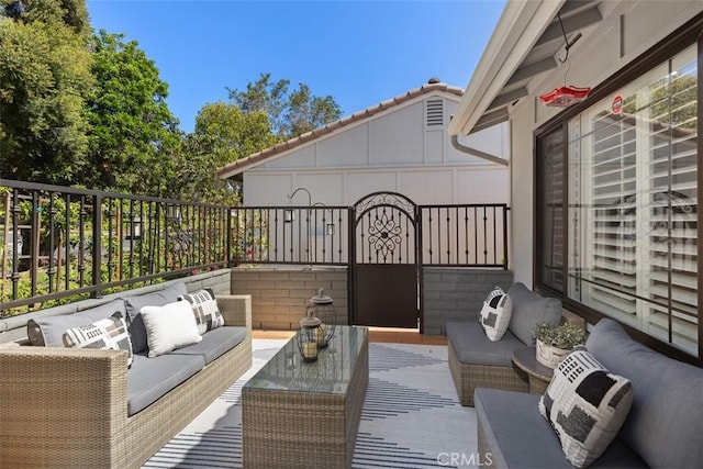 view of patio with fence and outdoor lounge area