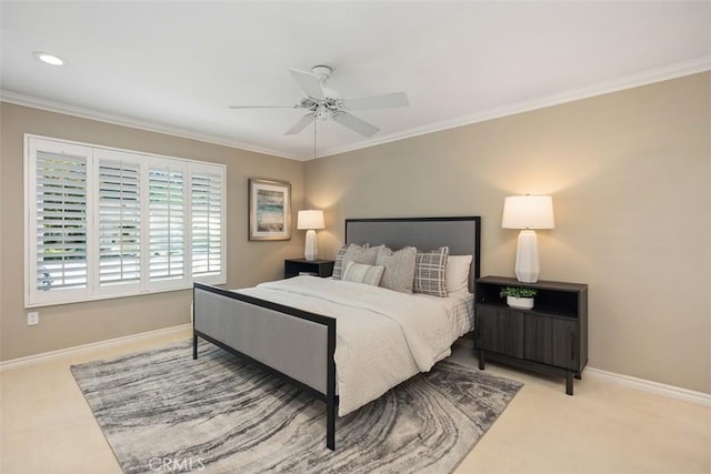 carpeted bedroom with a ceiling fan, baseboards, and ornamental molding